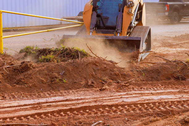 istock Construction equipment clears debris from a construction site in a sunny afternoon in a busy urban area 2192678404