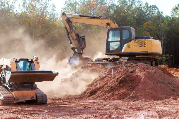 istock Heavy machinery working on construction site with dust rising in the afternoon light 2192678414