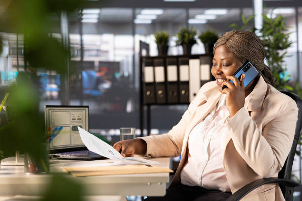istock Joyous CEO talking on phone while looking over business revenue charts 2192679419