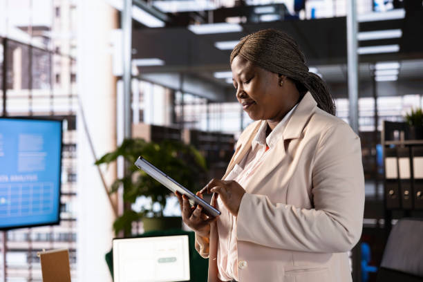 istock Businesswoman using tablet to analyze market trends and data in office 2192681498