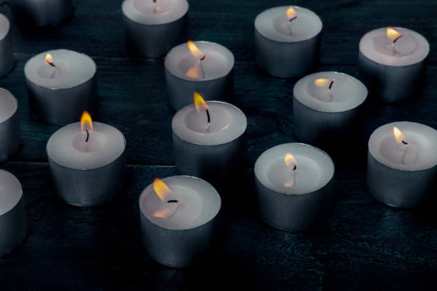 istock Tea light candles on a dark background, many lights in the dark 2192682727