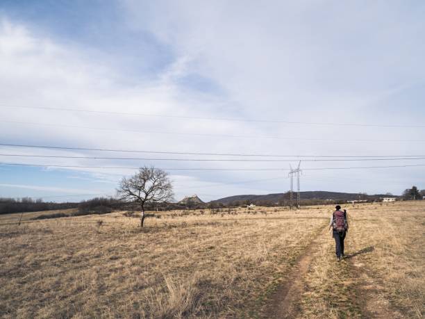istock Hiker walking on rural trail with distant landscape 2192683325
