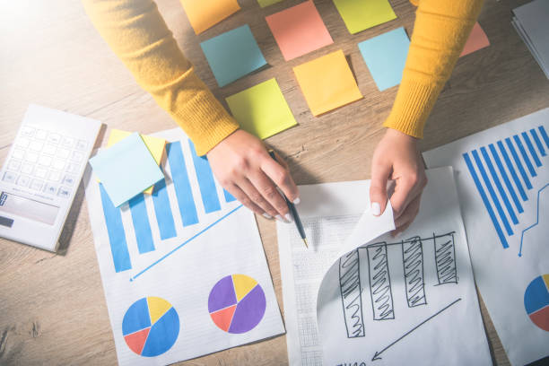 istock a person sitting at a table with papers and a pen 2192683432