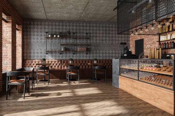 Empty Coffee Shop Interior With Wooden Tables, Chairs, Cake Display Fridge And Pendant Lights