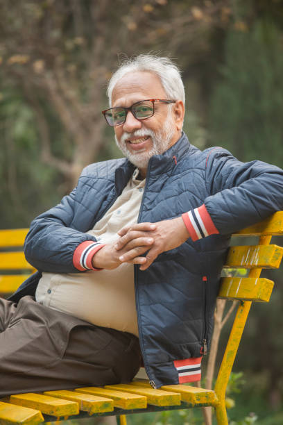 istock Happy senior man relaxing on bench in park 2192684213