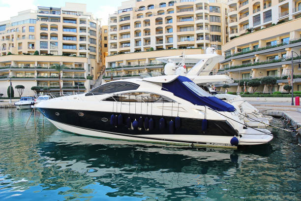 Stunning speed motor boats in Port Hercules in Monaco. Behind residential buildings on hill (maybe Monte Carlo  district) in sunny summer day!