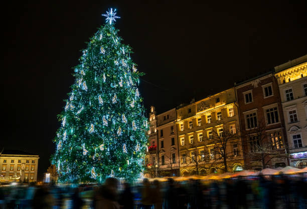 istock Illuminated Christmas Tree in City Square Surrounded by Festive Crowds 2192686520