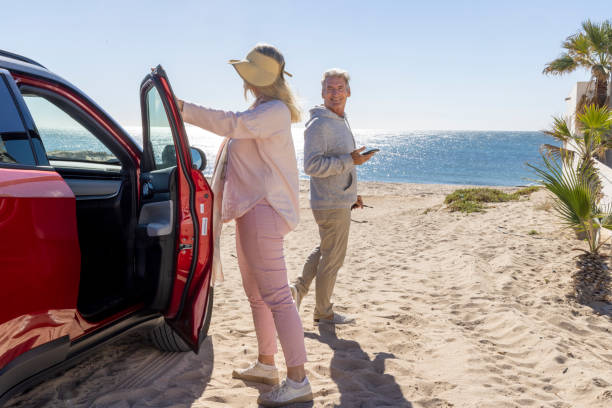 istock Mature couple leave car parked on beach 2192686927