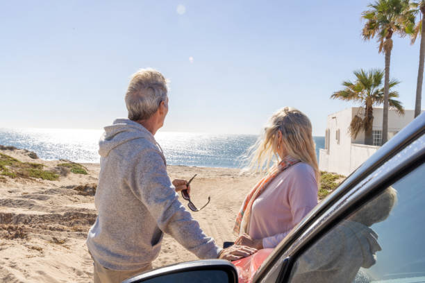 istock Mature couple relax near car on beach 2192687796