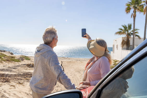 istock Mature couple relax near car on beach 2192687797