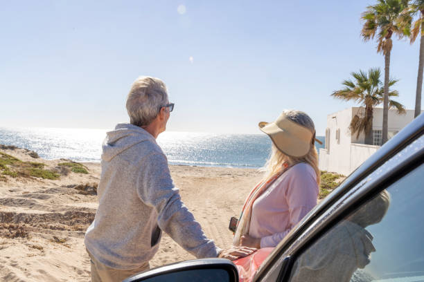 istock Mature couple relax near car on beach 2192687864