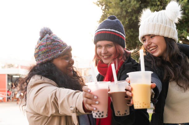 istock Cheerful teenagers toasting with bubble tea outdoors in winter 2192688180