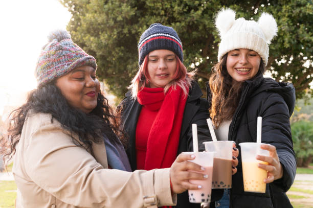 istock Cheerful young women toasting with bubble tea outdoors in winter 2192688182