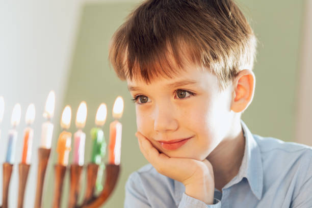 istock 7 year old boy celebrates Hanukkah 2192688895