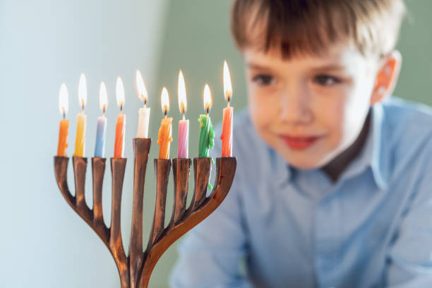 istock 7 year old boy celebrates Hanukkah 2192688956