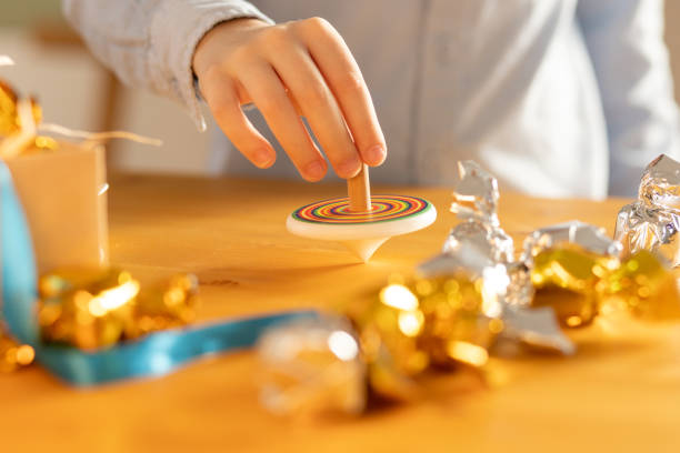 Japanese New Year's images. / spinning tops and fan and Paper-cutting Sakura with pink Japanese paper background.