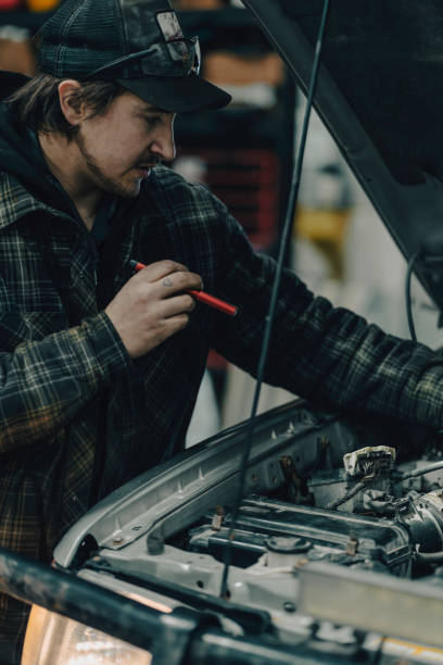 istock Mechanic fixes vehicle in repair shop 2192689466