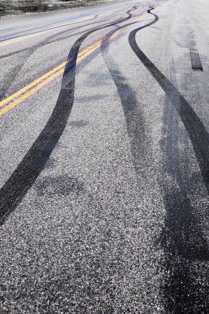 Tire Tracks on Road Burning Rubber Peeling Out Skid Marks on Asphalt