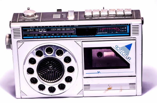 A white radio with a blue triangle on it. The radio has a dial and buttons