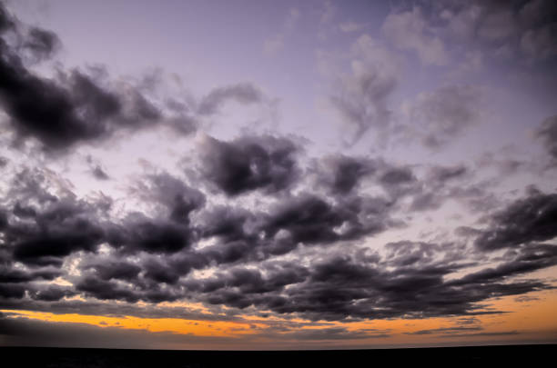 istock The sky is filled with dark clouds and the sun is setting 2192691619