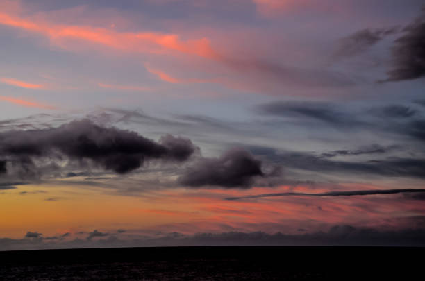 istock The sky is filled with clouds and the sun is setting 2192691622