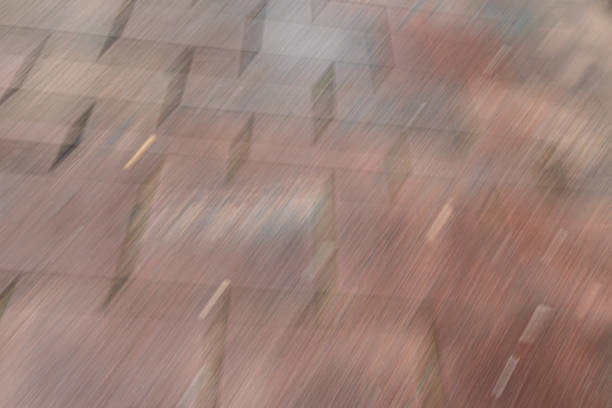 A view of a textured paved surface in a city area.The ground shows signs of movement - motion blur