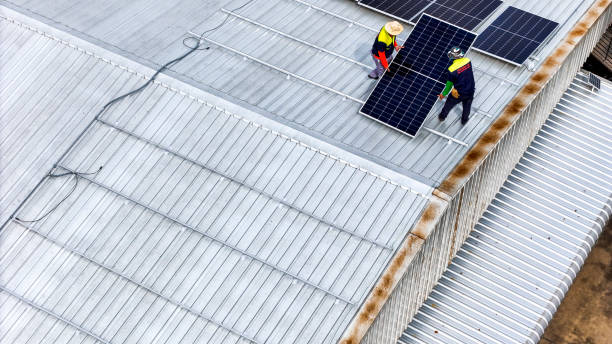 istock A sustainable energy project featuring solar panels on a roof surrounded by tropical trees, highlighting renewable energy efforts and the integration of green technology into rural areas. 2192692723