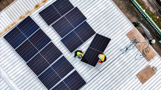 istock A sustainable energy project featuring solar panels on a roof surrounded by tropical trees, highlighting renewable energy efforts and the integration of green technology into rural areas. 2192694605
