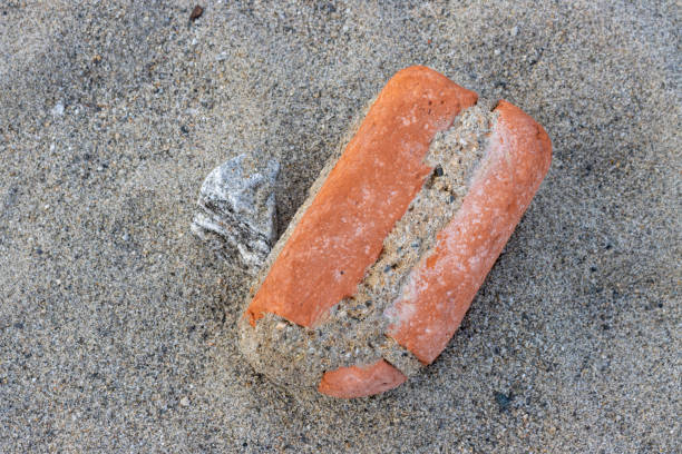 Beauty of an old brick, washed out from the sea during the high tide. Rounded edges from the power of the sea. Beach of Tyrrhenian sea, Sicily, Italy.