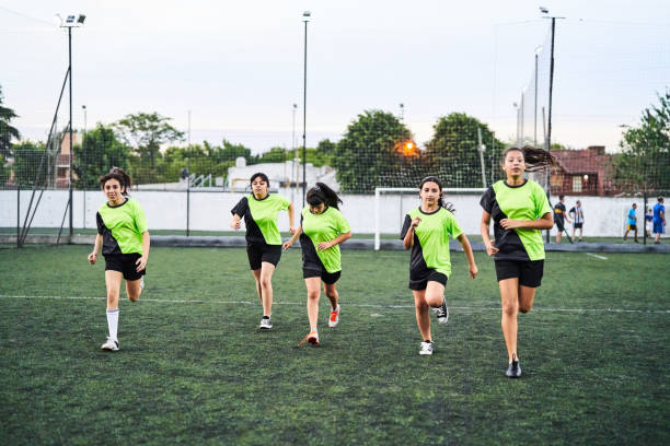 istock Girls soccer team doing running workout on field 2192696093