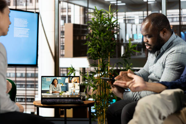istock Man doing videocall with colleagues in company office 2192696301