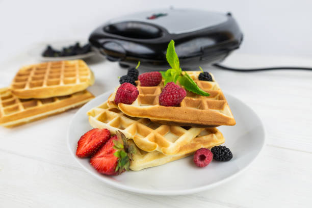 istock Belgian waffles with different berries on white.Sweet waffles in a white plate. 2192698516