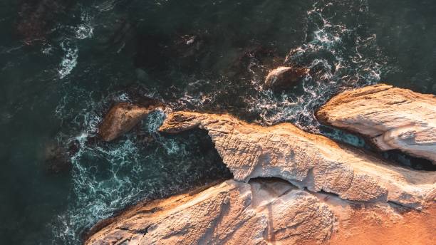 istock Aerial view of coastal cliffs and waves at sunset. 2192698604
