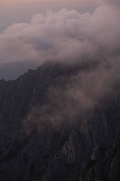 Sunrise over forest and mountains in mist