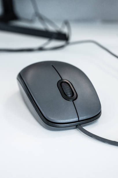 istock Closeup of a grey computer mouse at an office desk.. 2192699376