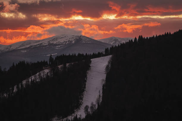 Sunset over ski resort and forest in winter