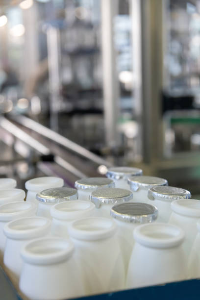 istock Milk processing facility with sealed and open containers ready for distribution in a clean, modern environment 2192699644