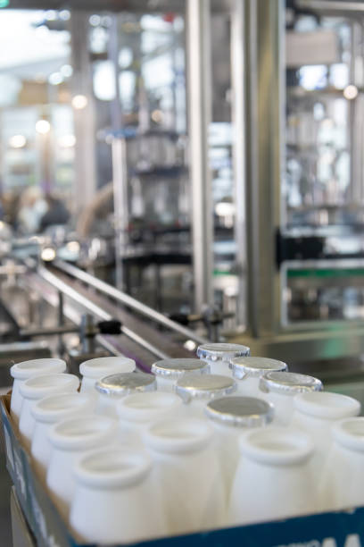 istock Milk processing facility with sealed and open containers ready for distribution in a clean, modern environment 2192699649