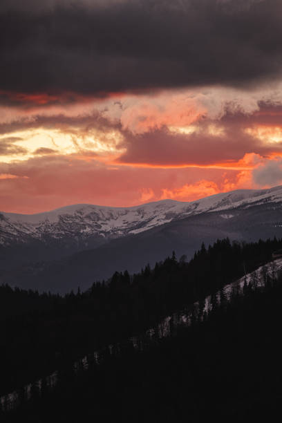 Sunset over ski resort and forest in winter