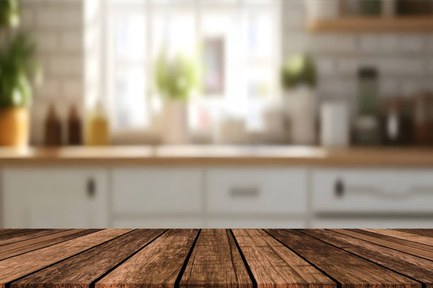 istock Empty beautiful wood table top counter and blur bokeh modern kitchen interior background in clean and bright,Banner, Ready for product montage 2192699860