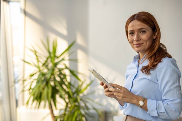 istock Businesswoman exploring ideas on her tablet at work 2192700279