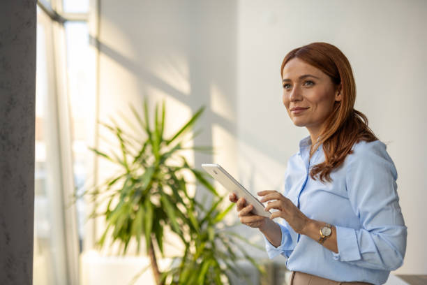 istock Businesswoman exploring ideas on her tablet at work 2192700283