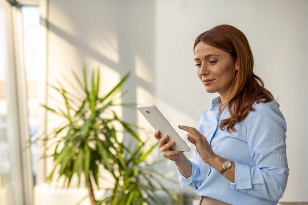 istock Businesswoman exploring ideas on her tablet at work 2192700297