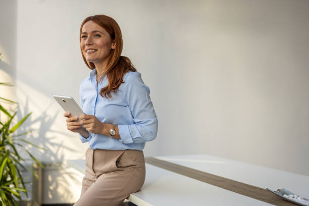 istock Businesswoman exploring ideas on her tablet at work 2192700310