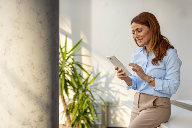 istock Businesswoman exploring ideas on her tablet at work 2192700315