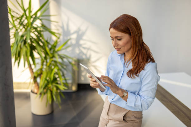 istock Businesswoman exploring ideas on her tablet at work 2192700335