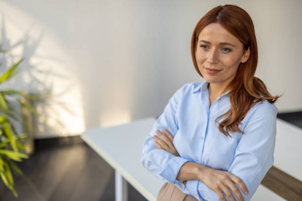 istock Professional woman standing with crossed arms 2192700390