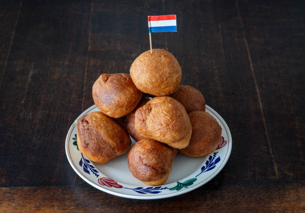 istock Stack of traditional dutch oliebollen on the plate decorated with dutch flag 2192701065