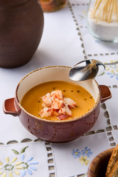 istock Gourmet Pumpkin Soup with Shrimp in Rustic Bowl - Vibrant and Artfully Composed Culinary Photography 2192704089