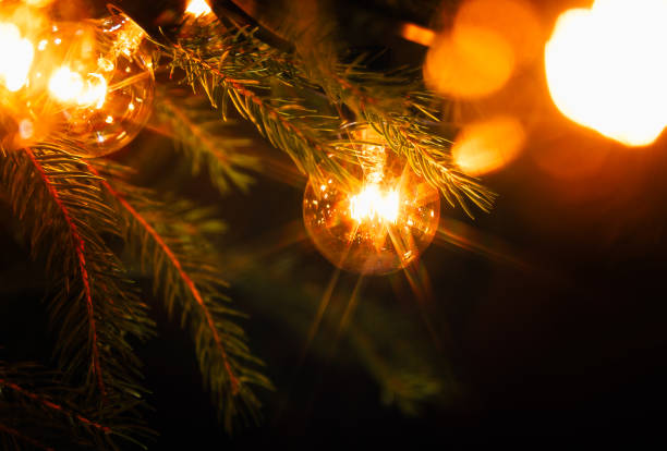 Background - electric garland with incandescent bulbs, yellow warm light, retro style, star filter, atmospheric close-up